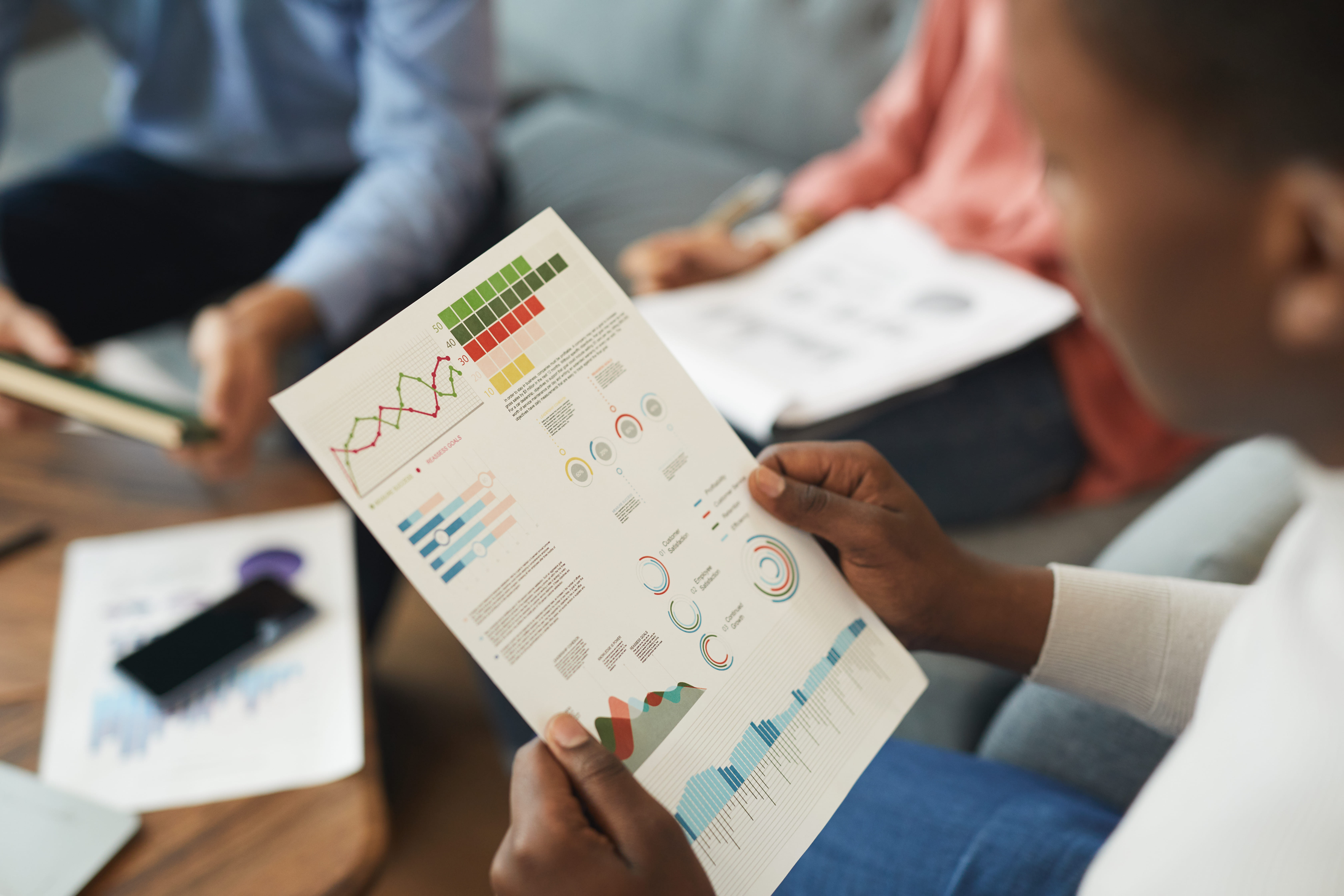 Investor reviewing real estate investment performance charts at a desk