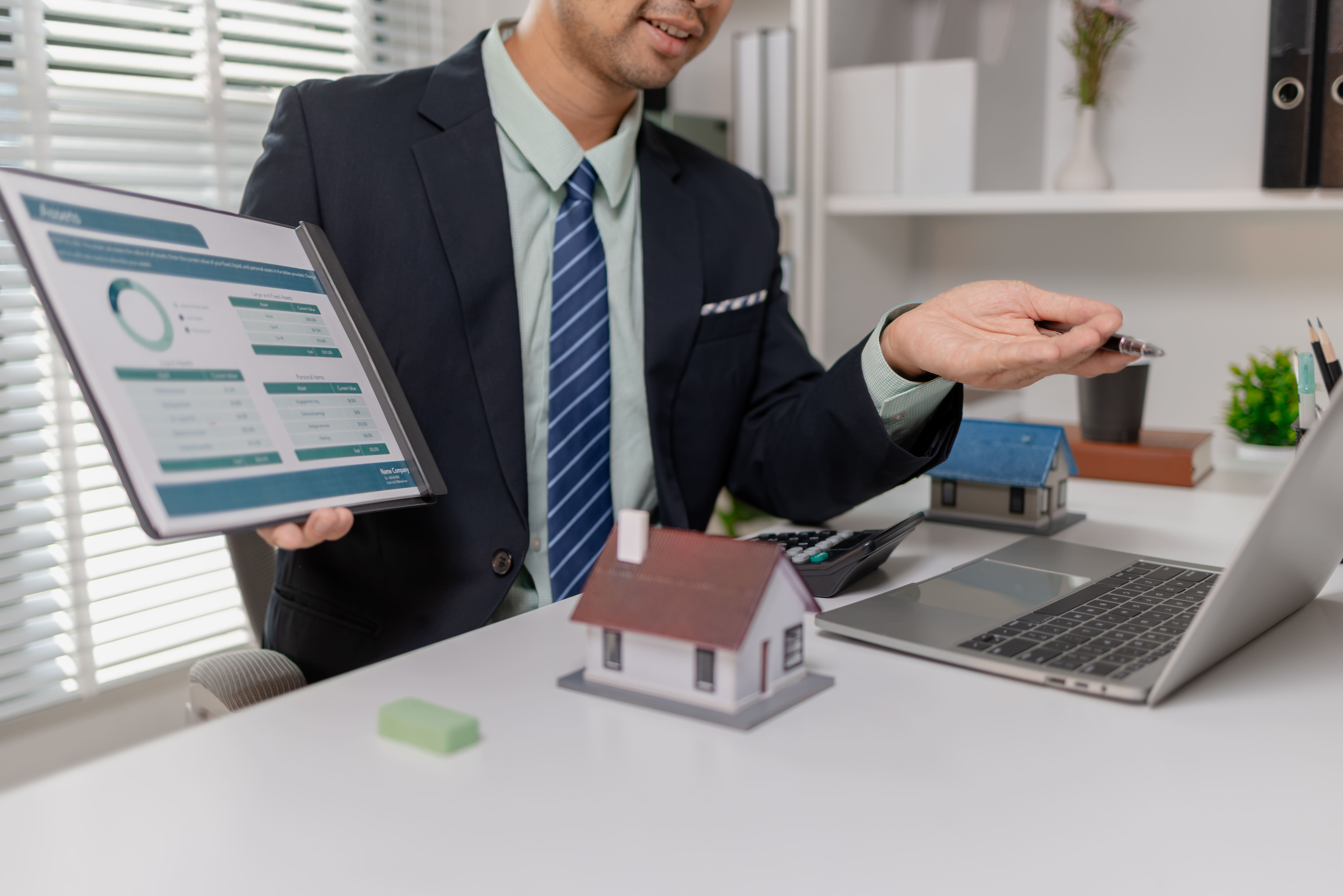 Advisor presenting a financial report and property keys to a client