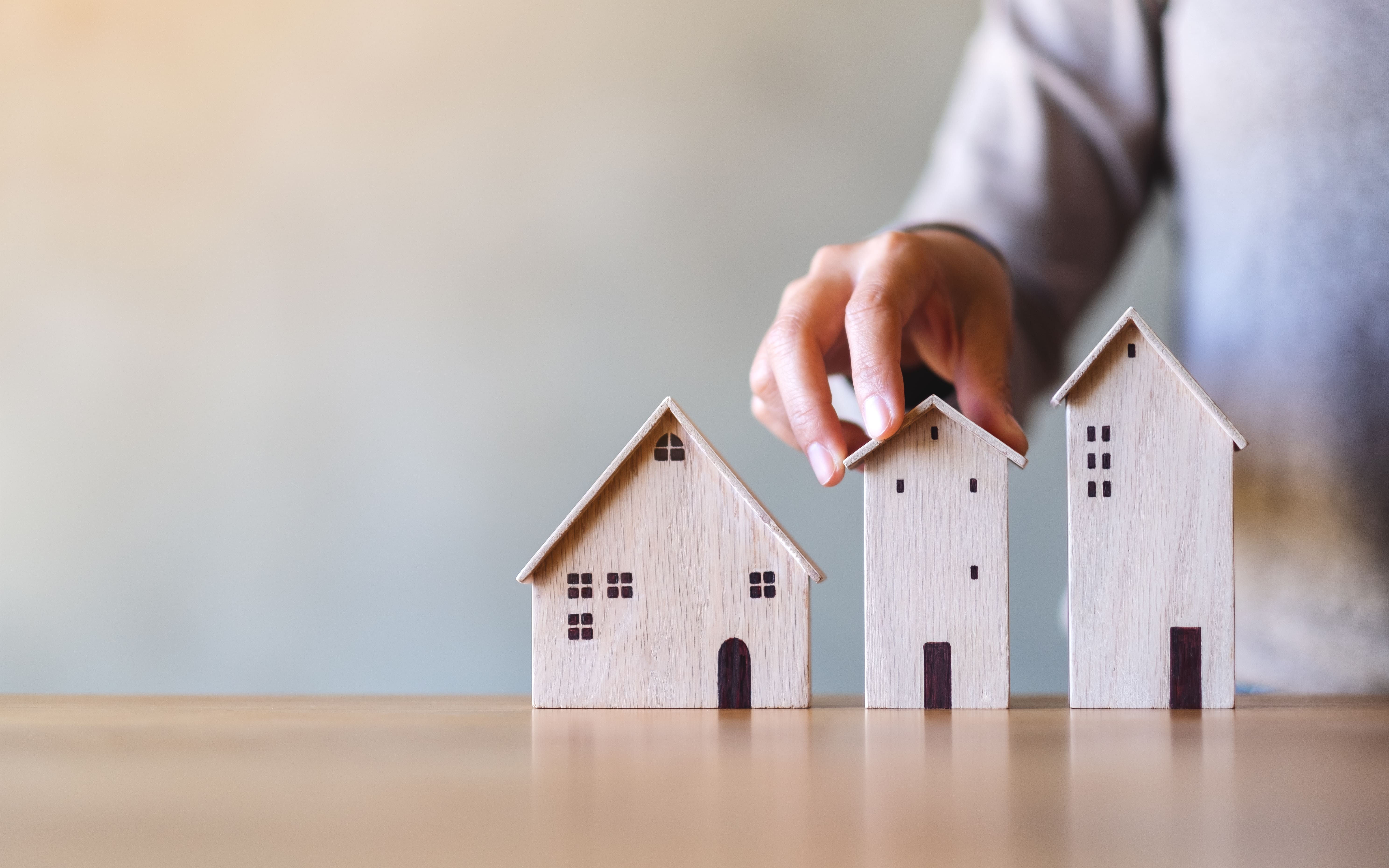 Miniature houses representing housing market inventory and home ownership