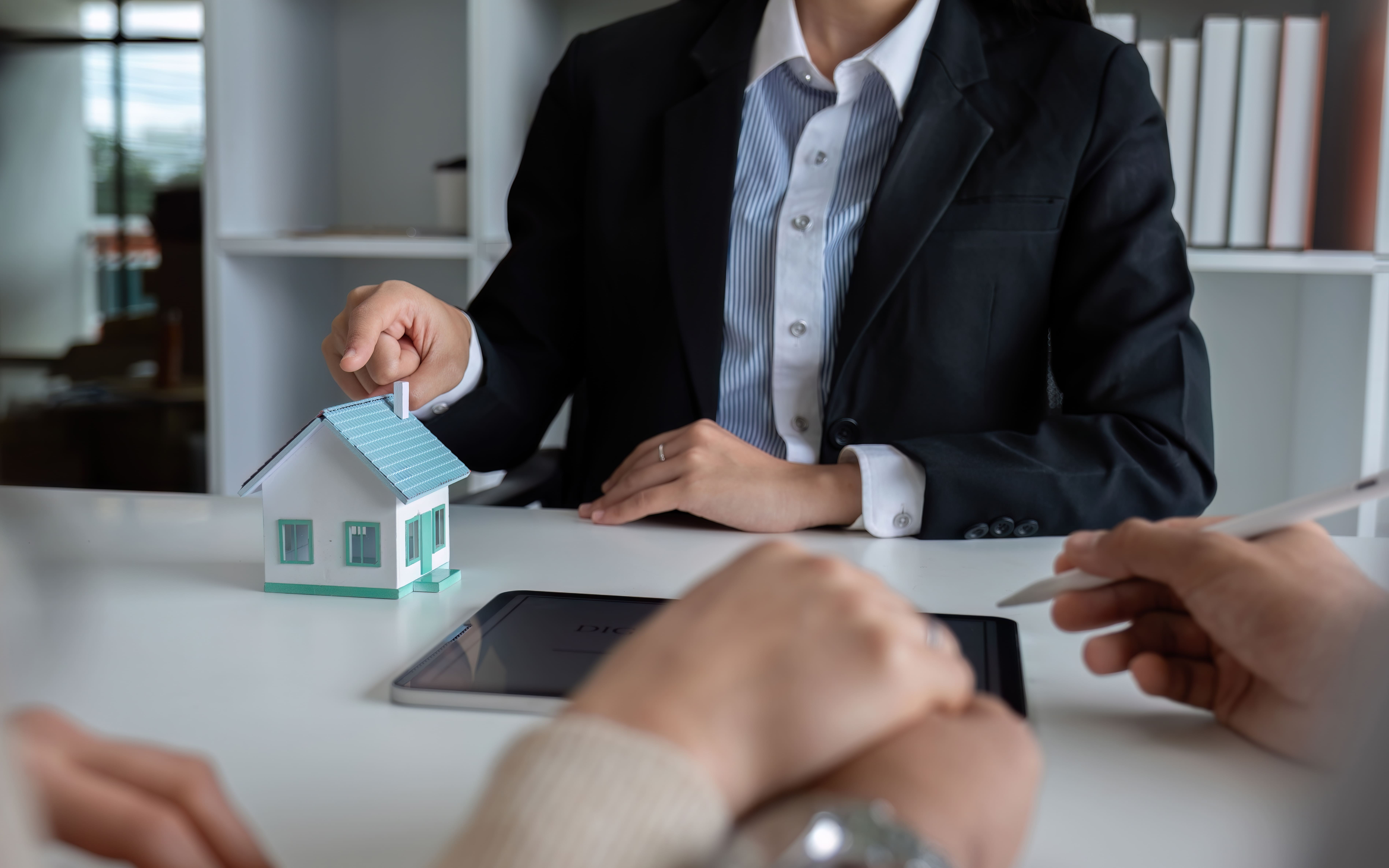 Agent presenting a property model to a client for investment consideration