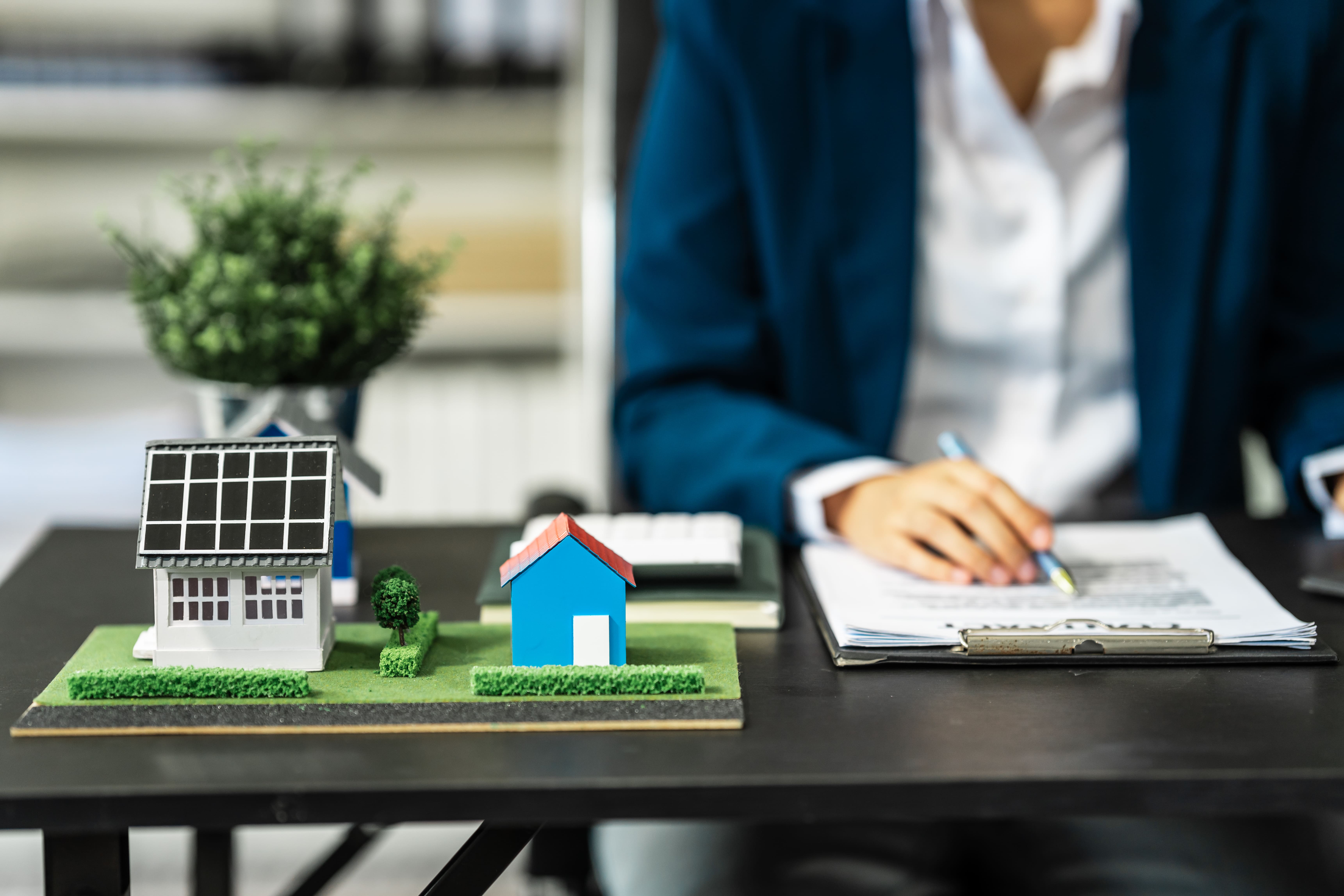 Agent reviewing multiple property models alongside a contract document