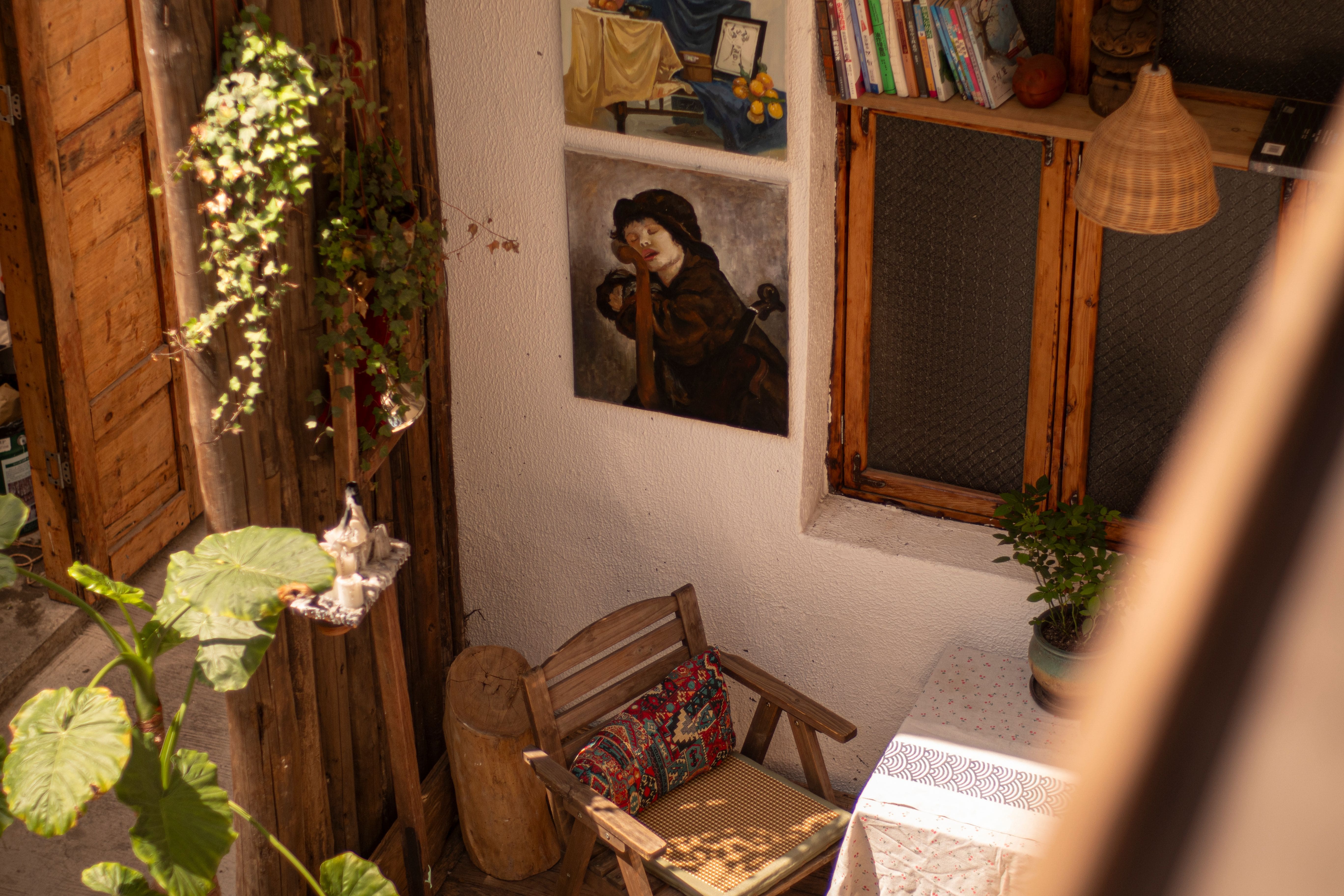 Charming outdoor courtyard of a short-term rental with vintage art and plants
