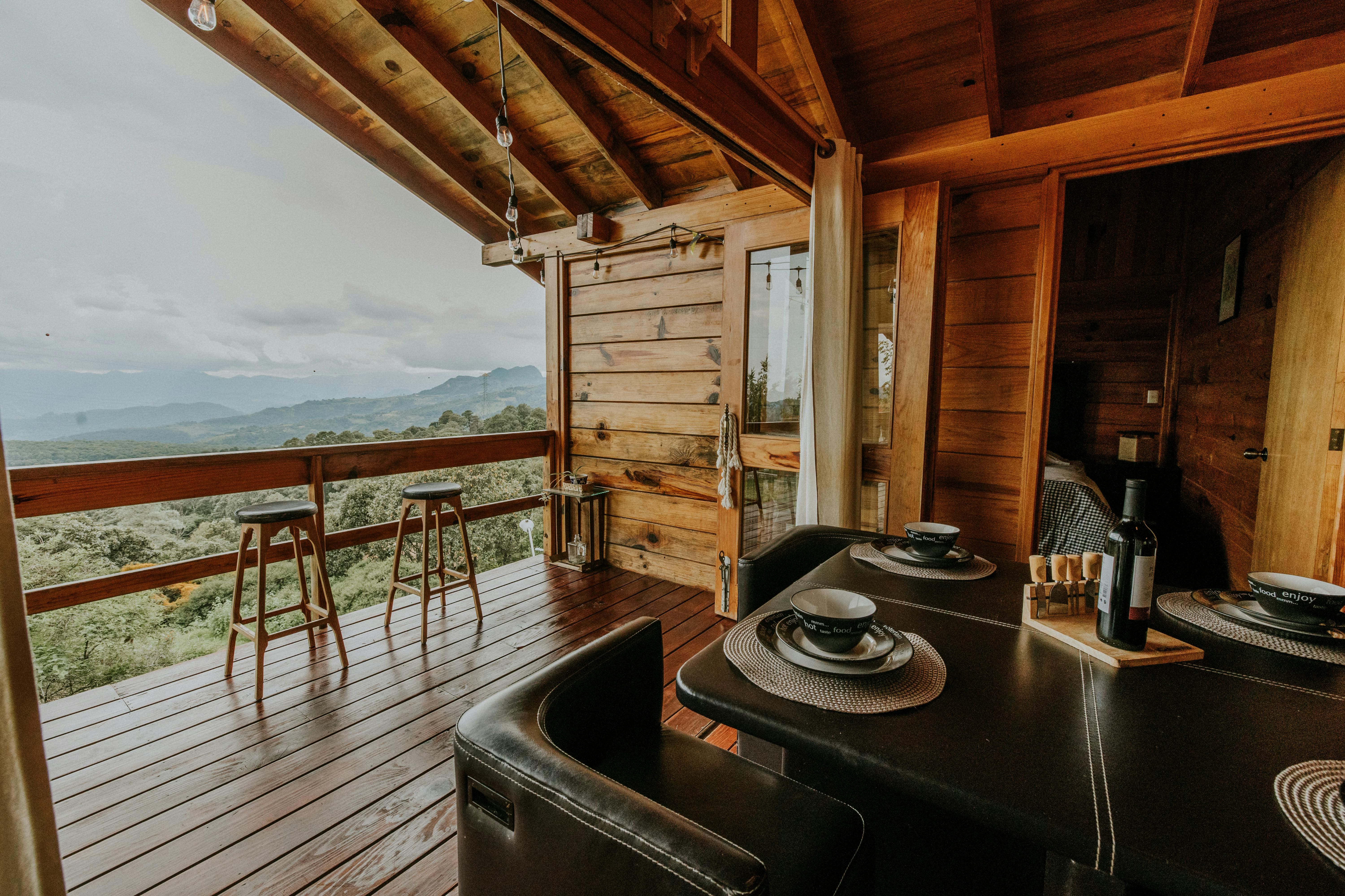 STR cabin deck with outdoor dining table and mountain valley views