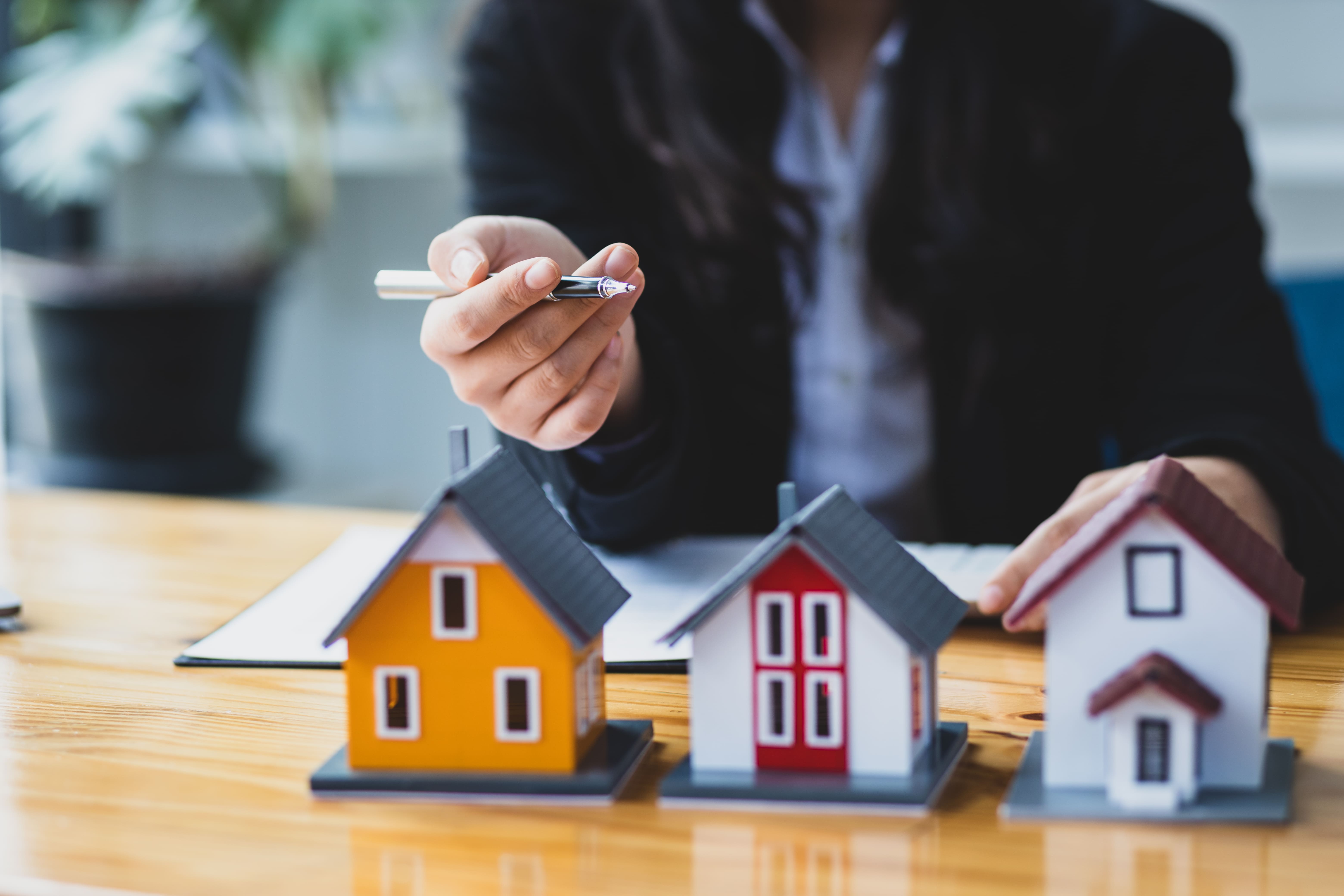 Real estate agent presenting a model home to a prospective buyer
