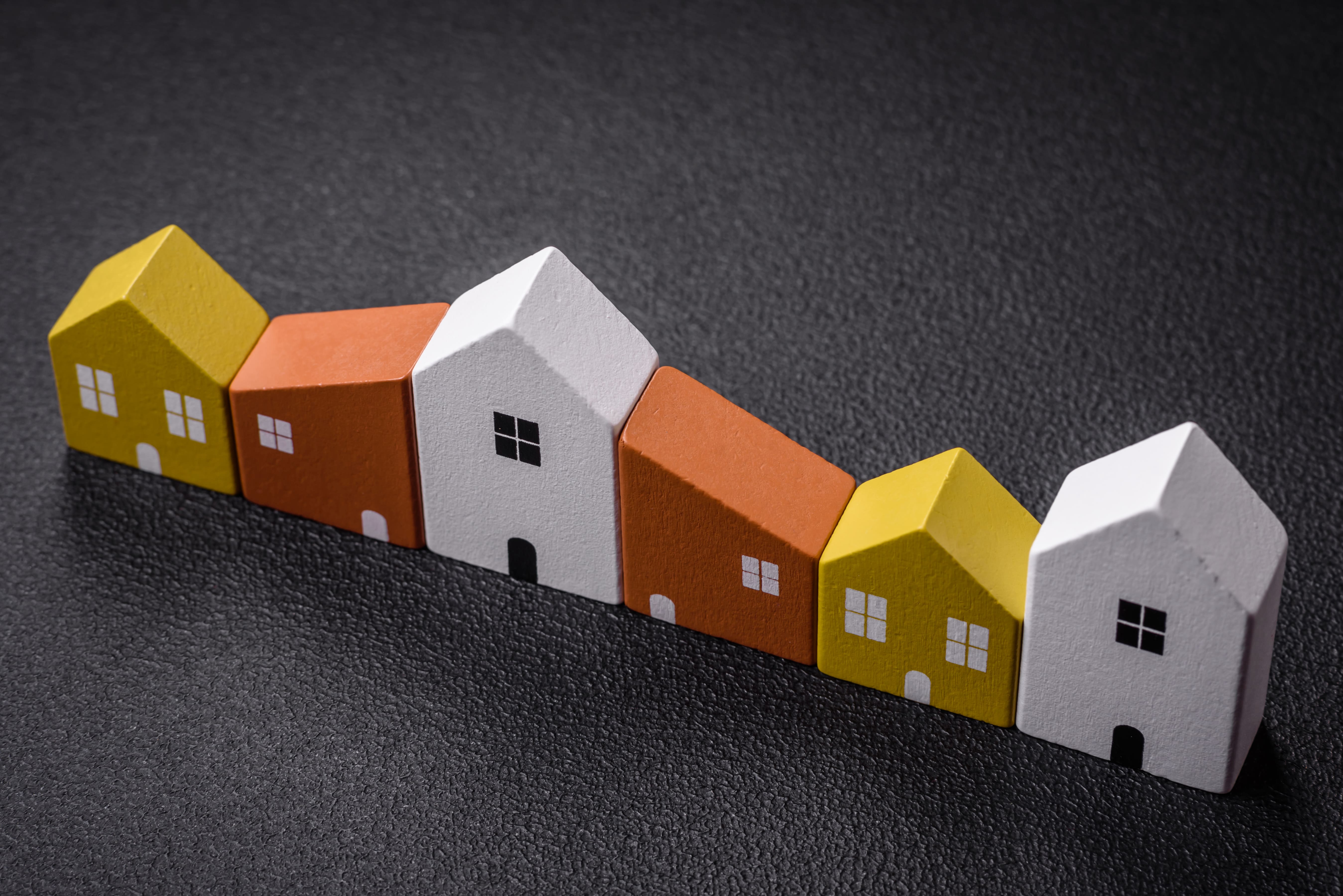 Colorful wooden houses representing real estate market inventory levels
