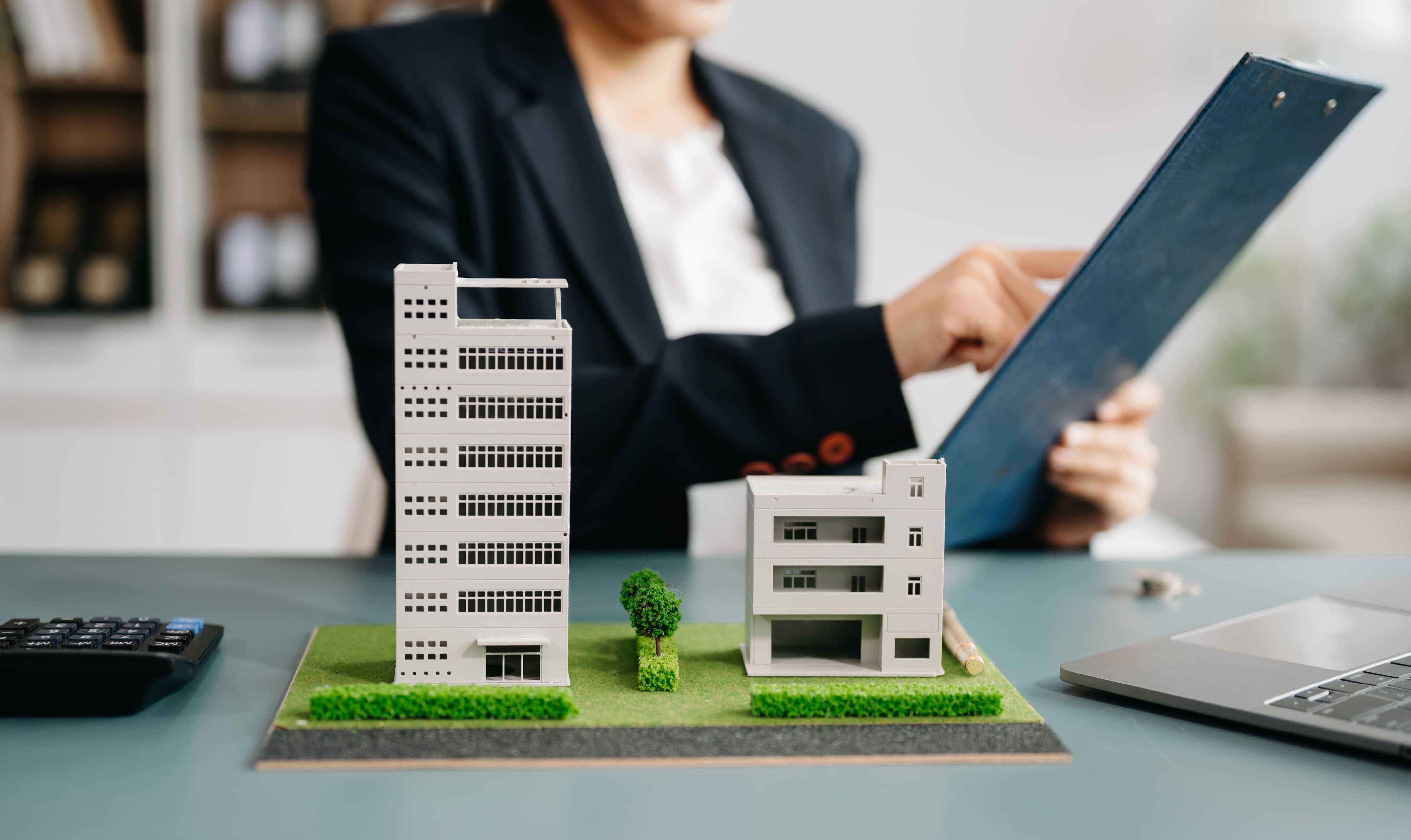 Professional reviewing multifamily building models for leasing or investment