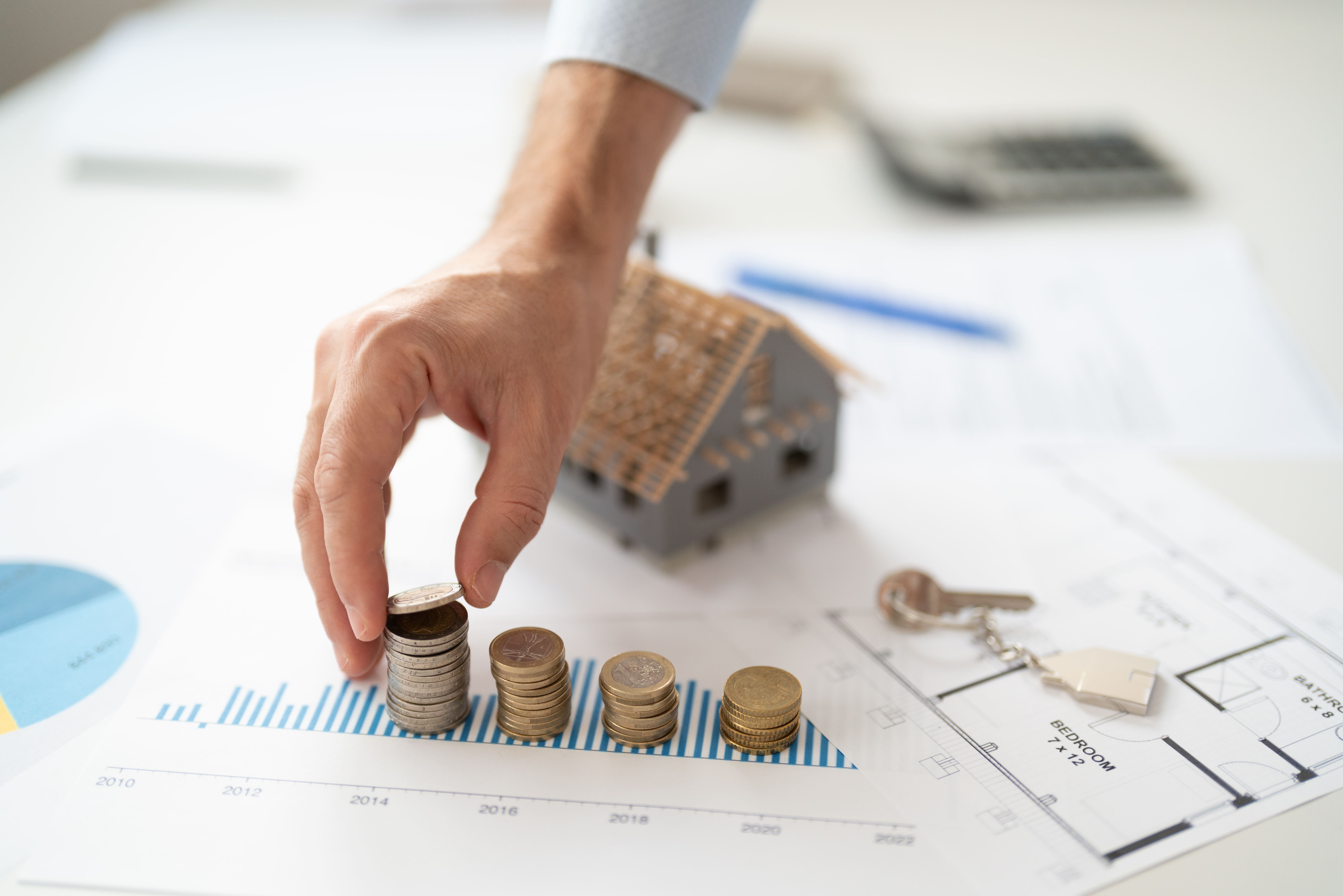 Coins stacked on a financial chart representing investment performance
