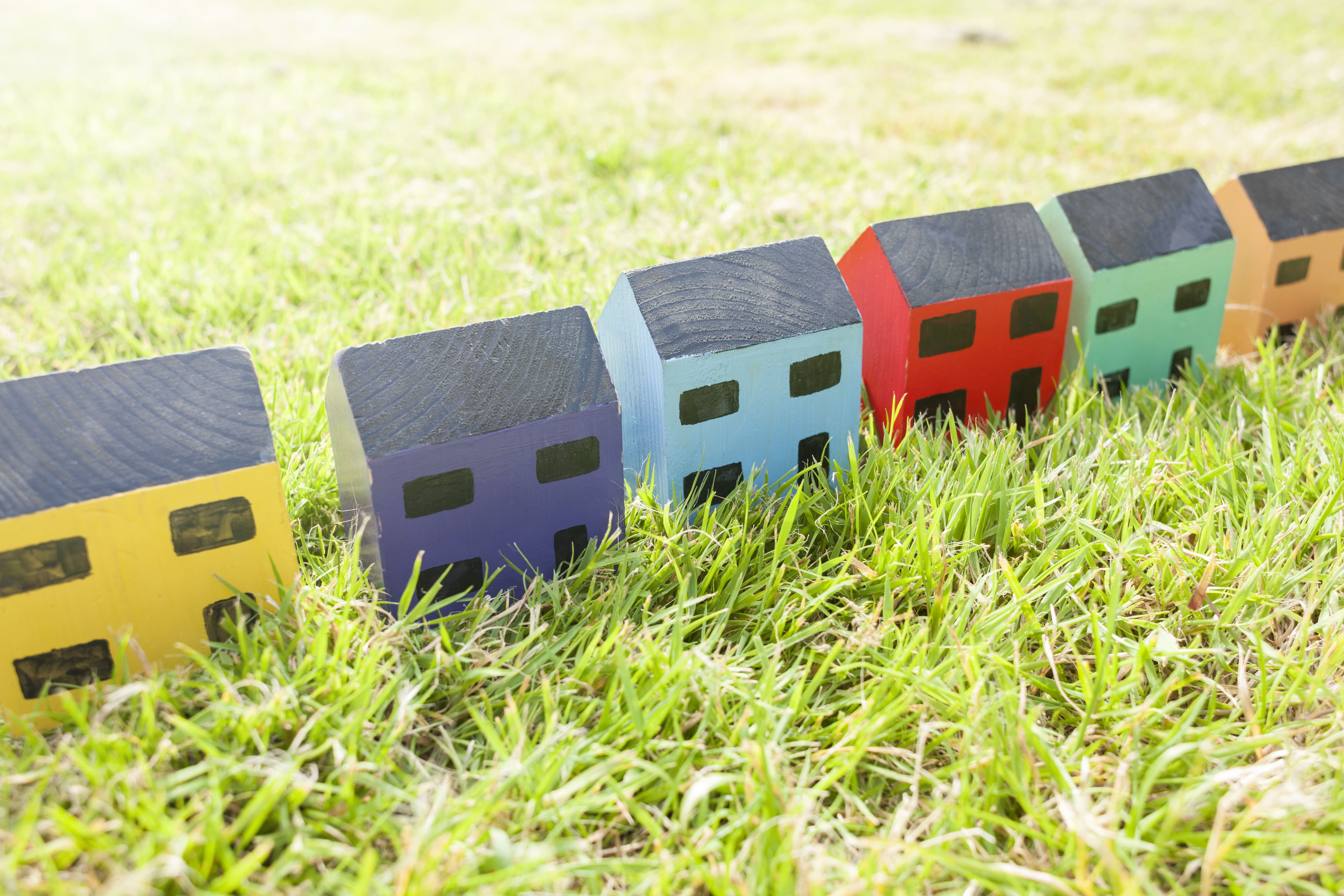 A row of houses representing a real estate neighborhood market