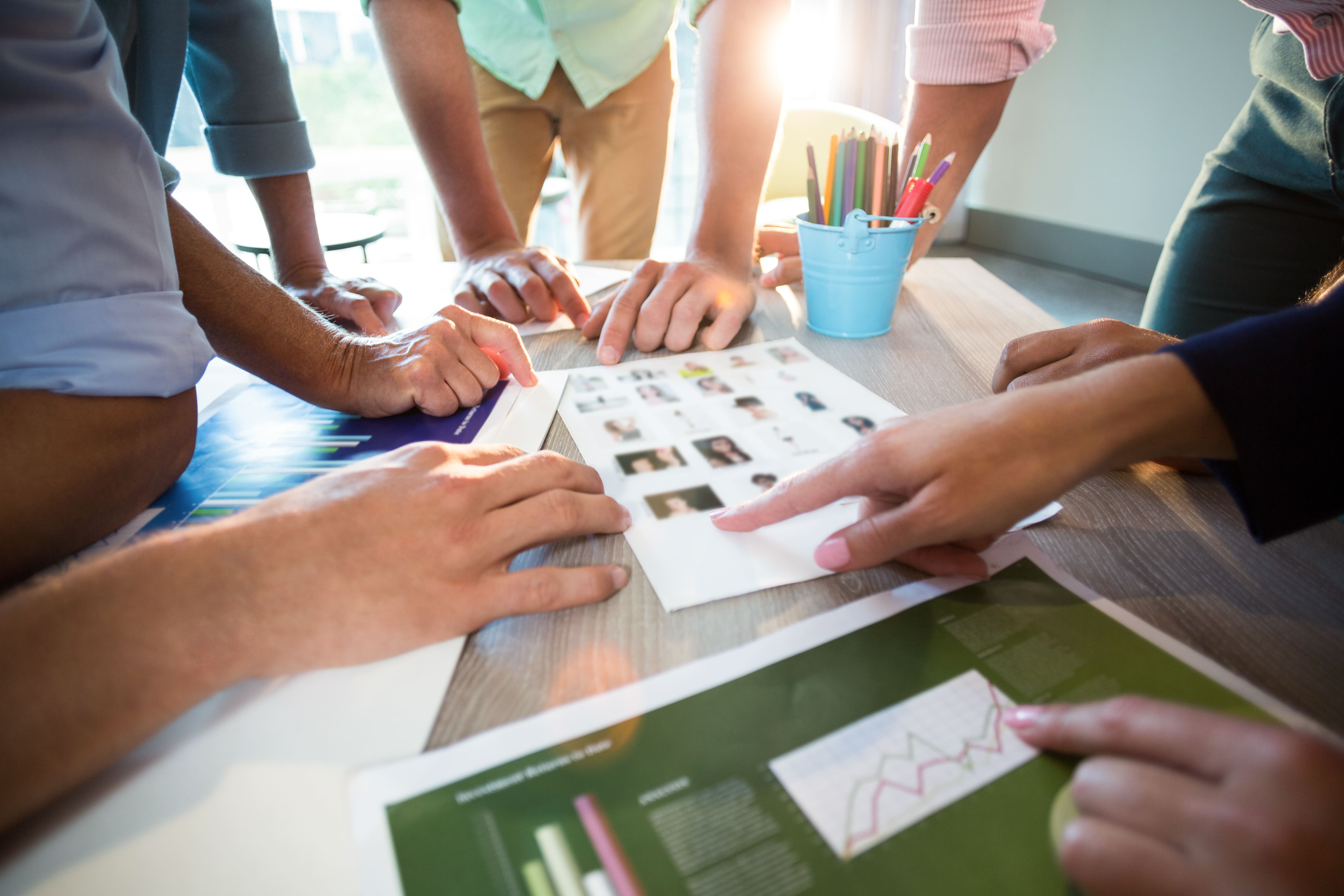 Marketing team reviewing real estate investor presentation materials